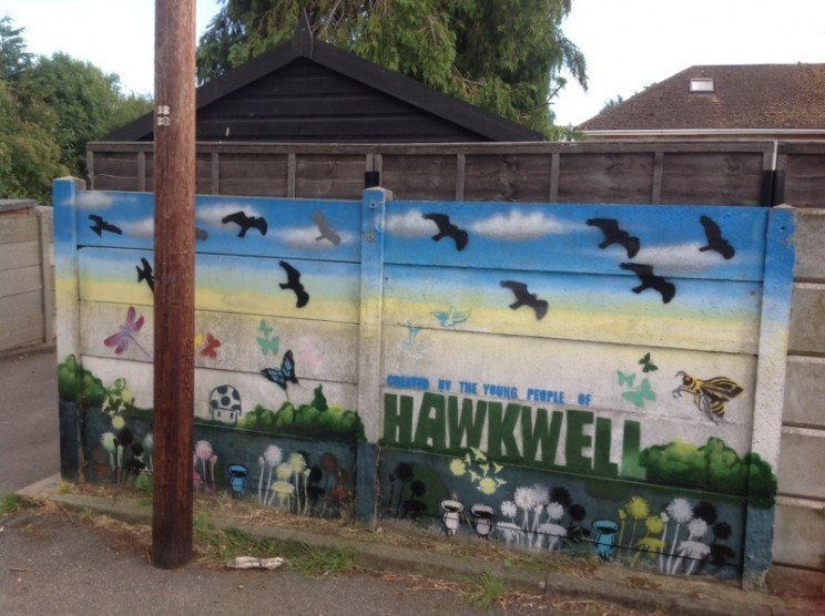 There's a car park at the entrance  , with an extensive mural by local young people.